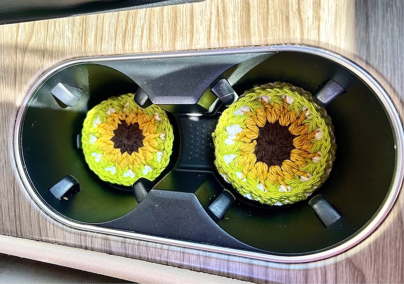 Sunflower crochet coasters placed in car cup holders